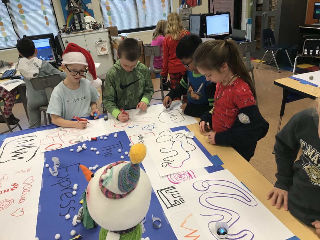 A picture of kids participating in The Ozobot Express STEM lesson