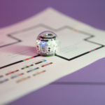 February STEAM Lessons: a picture of Evo coding robot on color code lines for Prominent Black Engineers & Scientists activity