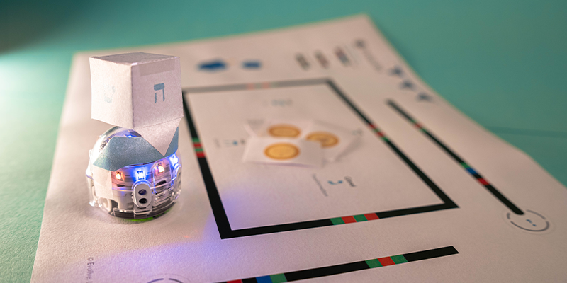 Video lessons for the holiday. A picture showing Evo dressed up as a dreidel in this STEAM lesson